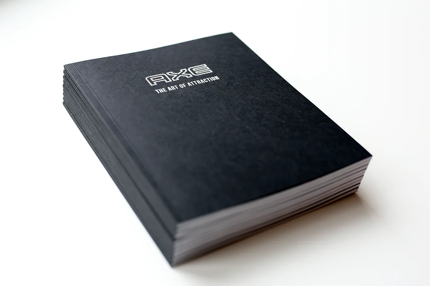 Axe The Art of Attraction research book with an embossed black cover