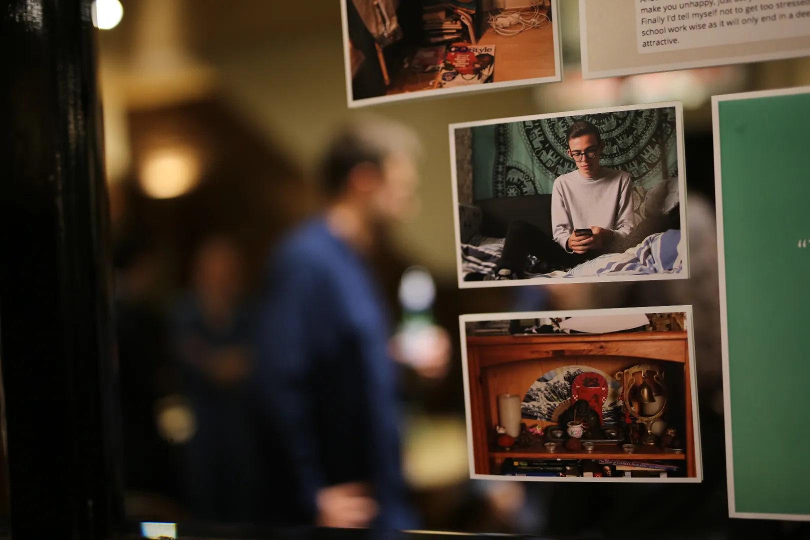 Visitor viewing photo research displays from a male identity study at a Crowd DNA exhibition